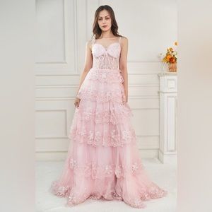 Pink corset top prom dress with layers and a slit